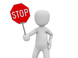 TravelAfter5_Dumb Money-Saving_Doll Holding Stop Sign